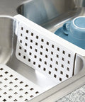 Kitchen Sink Mat Protector 11 By 12 Inches White Open Grid Plastic Sink Mat For Dish Protection In Kitchen Bathroom And Laundry Sinks The Euro Collection shown in use over a sink divider.