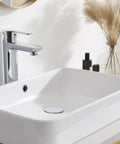 Solid Build Universal Pop Up Sink Drain Stopper With Overflow Chrome Finish Anti Clog Design For Kitchen And Bathroom Sinks in white sink.