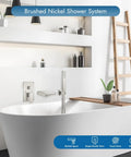 Wall Mount Waterfall Tub Faucet With Handheld Sprayer And Single Handle Lever Rough-In Valve Shower Diverter Kit in brushed nickel above bathtub.