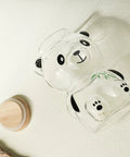 Airtight Glass Coffee Bean Jar With Fun Panda Lid Keeps Whole Beans And Grounds Locked In Heat Resistant Transparent Tea Sugar Canister Top Shelf Fresh Storage For Coffee Crew viewed from above against a white background.