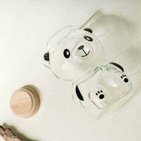 Airtight Glass Coffee Bean Jar With Fun Panda Lid Keeps Whole Beans And Grounds Locked In Heat Resistant Transparent Tea Sugar Canister Top Shelf Fresh Storage For Coffee Crew viewed from above against a white background.
