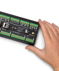Hand holding Portenta Machine Control Industrial Beast Controller for automation robotics and IoT with dual-core processor.