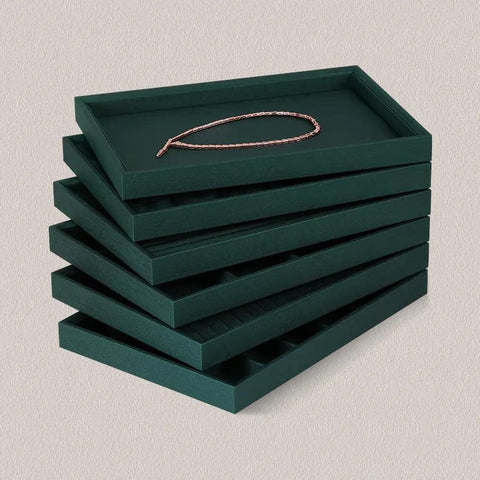 Top Tier PU Leather Jewelry Display Tray Featuring Twenty Four Secure Grid Slots For Rings Earrings And Brooches stacked with a necklace.