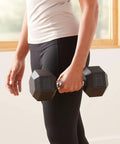 Person holding a 20 Pound Hex Dumbbell With Rubber Encased Cast Iron Core And Non Slip Contoured Handle For Home Gym Strength Training.