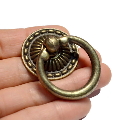Close-up of 8-Piece Bronze Drawer Ring Pulls Set With Screws For Dresser Cabinet Wardrobe Chest Closet Vintage Decorative Hardware.