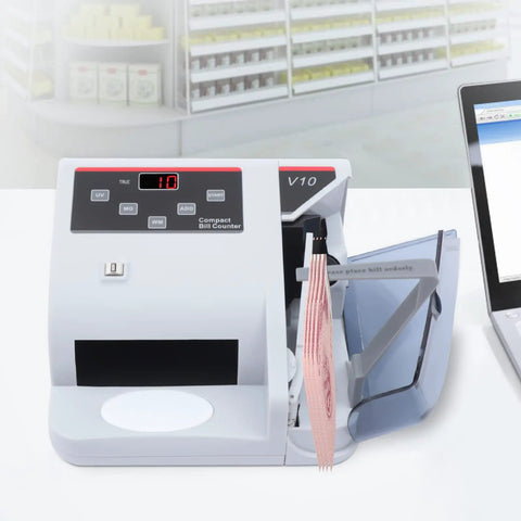 Money Counter Machine With UV MG WM Counterfeit Detection on a desk next to a laptop, displaying bill insertion and LED display.