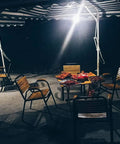 Outdoor dining area at night illuminated by Ultra Bright Outdoor LED Motion Sensor Flood Light 12-24V AC/DC Waterproof Security Lamp.