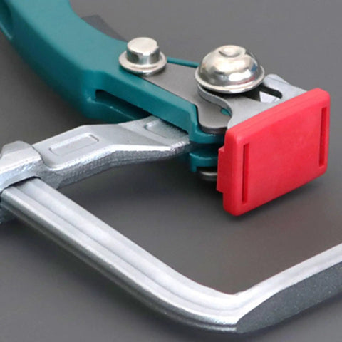 Close-up of steel table clamp with ratchet lock and quick release, part of Beefy And Stable Bench Dog Hole Clamps For Woodworking Tables.