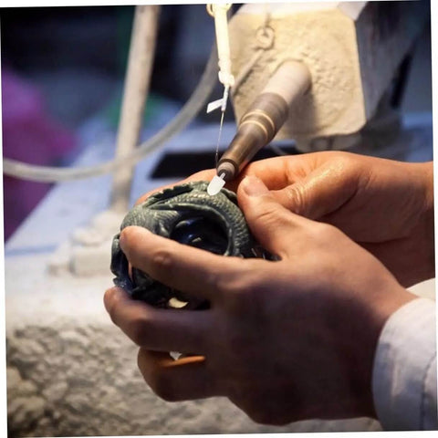 Hand using 120Pcs Wool Felt Polishing Wheel Set With Mounted Shank For Rotary Tools on metal jewelry, side view, in use