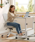 Height Adjustable Rolling Computer Desk With Storage Shelves Waterproof And Warp Resistant Portable Standing Workstation in a bright home office.