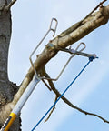 Rope Sniper Pro Arborist Tool for effortless rope placement on a tree branch, enhancing speed and safety in rigging.