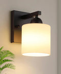 Chill Out Matte Black Milk Glass Wall Sconces Bringing Soft Warm Light To Your Space Premium Metal Build Rust Resistant Finish Dead Simple Hardwired Wiring Ceramic E26 Socket featuring a frosted glass shade.