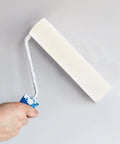 Hand holding a sponge paint roller applying paint on a wall, showcasing the Sweet Ten Piece Sponge Paint Rollers For Super Swift Wall Painting And Killer Coverage A True Game Changer For Home DIY Jobs Quick Touch Ups And Straight Up Effortless Rolling Action Yielding A Smooth Professional Finish.