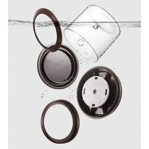 Round High Borosilicate Glass Coffee Bean Container With Real Deal Airtight Seal disassembled with lid and ring in water.