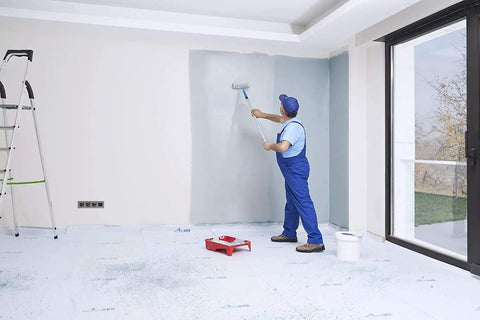 Person painting a wall with Temporary Floor Protection Roll 36 Inch By 100 Foot Anti Slip Surface Easy To Apply Paint Proof Reusable Durable Material