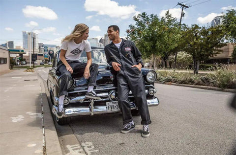 Rugged Men Long Sleeve Coveralls Built Like A Tank With 75 Oz Twill Mechanic Jumpsuit Featuring Zipper Front worn by two models by vintage car.