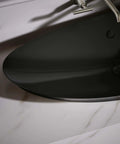 Close-up of Modern Trough Vessel Bathroom Sink With Asymmetrical Oval Basin Double Faucet Ready mounted on a sleek countertop.