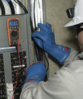 Electrician using Auto Ranging TRMS Digital Multimeter MM420 Pro Grade With 600V AC DC Voltage 10A on circuit panel.