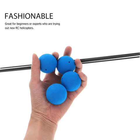 Hand holding blue sponge-ball practice balls from Three Set RC Helicopter Training Gear Kit with Blue Frame and Sponge Ball Practice Balls for Easy Learning and Flying, Ideal Starter Kit for Beginners and All Ages, Perfect for Safe Practice, showing product components.