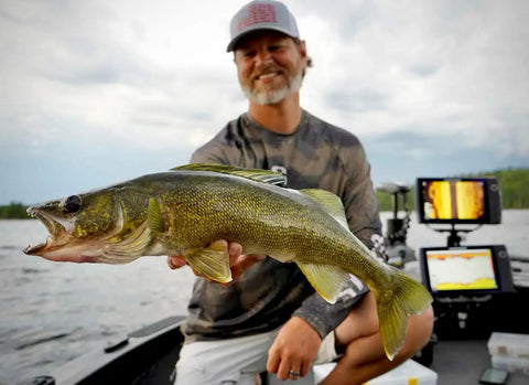 Angler on a boat holding a walleye fish, showcasing successful catch using Rock Runner Slip Bouncer Weight With Quick Change Precision Sinker.