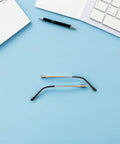 4 Pack Double Tooth Metal Glasses Arms Replacement Flexible Eyewear Temple Legs in gold tone, shown flat on blue surface