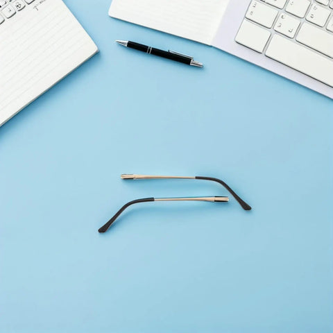 4 Pack Double Tooth Metal Glasses Arms Replacement Flexible Eyewear Temple Legs in gold tone, shown flat on blue surface