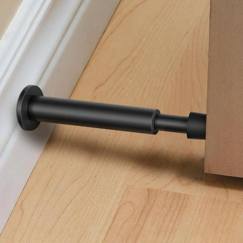 Heavy Duty 4.4 Inch Matte Black Door Stopper Set With Soft Rubber Tips, spring-loaded door bumper installed between door and wall.