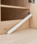 Six Piece White ABS Bottom Mount Drawer Slides Slick As Grease Cabinet Guide Rails view of installed rail in wooden cabinet.