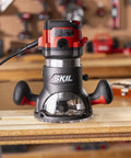 Heavy Duty 10 Amp Fixed Base Corded Router With A Beefy Two Point Zero Horsepower Motor and Variable Speed Control on a workbench.