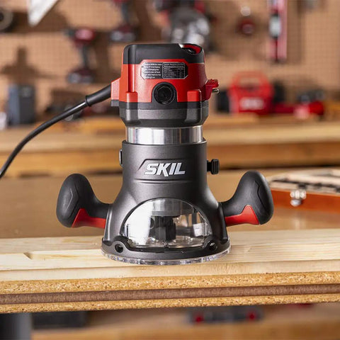 Heavy Duty 10 Amp Fixed Base Corded Router With A Beefy Two Point Zero Horsepower Motor and Variable Speed Control on a workbench.