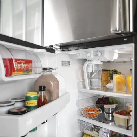Open refrigerator filled with various groceries including butter, milk, and vegetables with 40 Watt High Temp Appliance Oven Light Bulb installed.