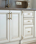 White kitchen cabinets with Six Pack 3 Inch Hole Center Cabinet Pulls Antique Brass Zinc Alloy Drawer Handles, enhancing furniture with vintage charm.