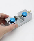 Hand holding Pro Grade Precision Gemstone Bonding Converter Stick Transfer Jig for Faceting, Working Aligner Locator with Horizontal and Vertical Seat, Gemstone Bonding Tool, Compatible With 5.8mm and 6.0mm Sticks and 1.5mm Pin, Easy Setup with blue knobs and metal body.