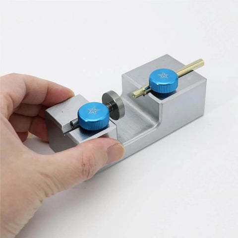 Hand holding Pro Grade Precision Gemstone Bonding Converter Stick Transfer Jig for Faceting, Working Aligner Locator with Horizontal and Vertical Seat, Gemstone Bonding Tool, Compatible With 5.8mm and 6.0mm Sticks and 1.5mm Pin, Easy Setup with blue knobs and metal body.