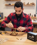 Man using Rock Solid 10 Pack Pen Kits For Woodturning, assembling a slimline pen with premium metal sliders.