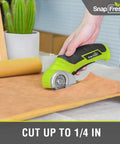 Cordless Electric Scissors 4V Mini Box Cutter With Replacement Blade And Charger For Cardboard, Carpet, Leather, Plastic, Quiet Low Noise Rotary Cutter For Packages And DIY Projects, Green being used to cut brown material