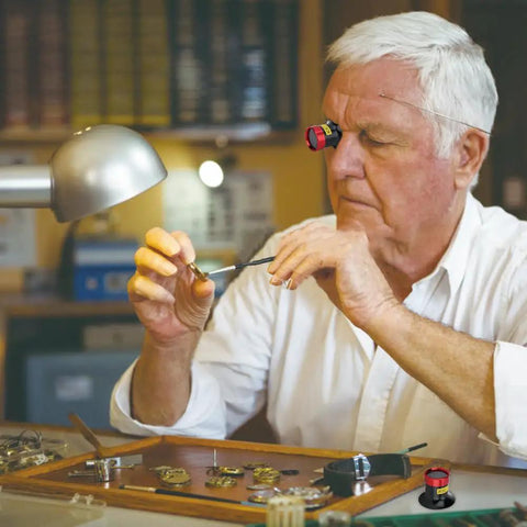 Man using 20X Watchmaker Loupe Magnifier for Pro Grade Precision, Portable Eye Loupe Glass Lens for Watches in a watch repair setting