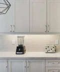 Modern kitchen with Brushed Satin Nickel 5 Inch Cabinet Pulls, 10 Pack with 128mm Hole Centers visible on white cabinets.