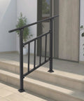 Heavy Duty Three Step Outdoor Steel Handrail Featuring Integrated Child Guard Panel And Weather Resistant Finish For Front Porch Stairs, black steel rail mounted on stone steps.