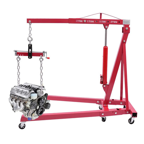 Heavy Duty Folding Hydraulic Engine Hoist Stand Built With Hella Tough Carbon Steel lifting an engine, featuring a durable design and hydraulic pump.