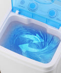 Compact Portable Washing Machine With 7.5 Liter Basin for Quick Laundry and Sneaker Scrubs showing water swirl in basin.