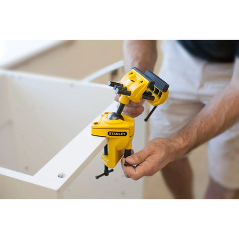 MaxSteel Multi Angle Hobby Vice With 360-Degree Ball Joint, yellow and black, clamped to a table corner.