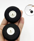 Five Piece Lightweight Foam RC Plane Wheel Set For RC Aircraft And Helicopters, Easy Install DIY Model Airplane Wheel Replacement, 2 Inch Diameter, Black visible in hand