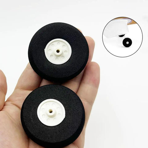 Five Piece Lightweight Foam RC Plane Wheel Set For RC Aircraft And Helicopters, Easy Install DIY Model Airplane Wheel Replacement, 2 Inch Diameter, Black visible in hand