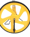 Badafaci Digital Measuring Wheel, 99,999.9Ft Range, Backlit Display close-up of yellow measuring wheel with black rubber rim.