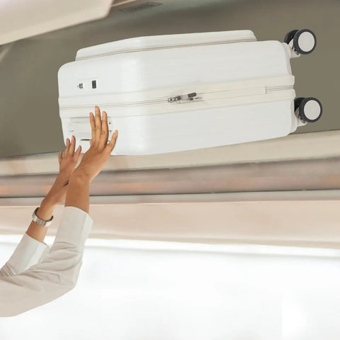 Person storing 18 Inch Underseat Carry On Luggage With Wheels Lightweight Hard Shell Suitcase in overhead compartment on plane.