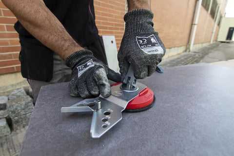 Worker using precision hole drilling guide with suction cup for dry and wet cutting on large tile surface