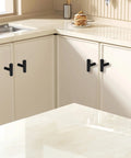 Six Pack 2 Inch T Bar Cabinet Knobs In Brushed Nickel Finish installed on white kitchen cabinets.