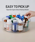 Hand picks bottle from Large Capacity Medicine Bottle Organizer For Cabinet With 9 In Diameter And 3.3 In Height, Clear Lazy Susan