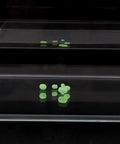 Glow In The Dark Soft Plastic Fishing Beads Set, 100 Pcs Green Egg Shaped Beads arranged on clear surface